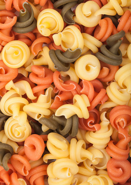 Raw homemade tricolore trottole pasta macro. Top view - Foto, afbeelding