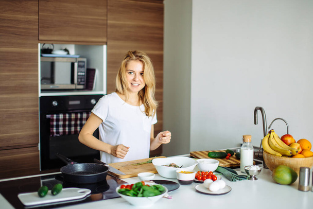 Pleasant young woman preparing dinner in a kitchen concept cooking, culinary - Φωτογραφία, εικόνα