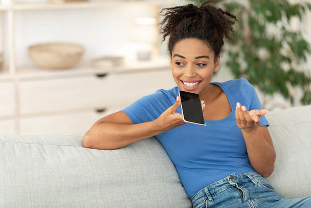 Černá dívka mluví po telefonu pomocí reproduktoru režimu doma - Fotografie, Obrázek