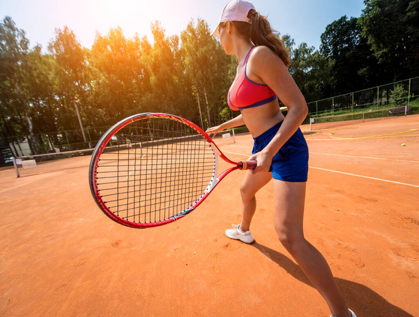 Young athletic woman playing tennis on the court. - Zdjęcie, obraz