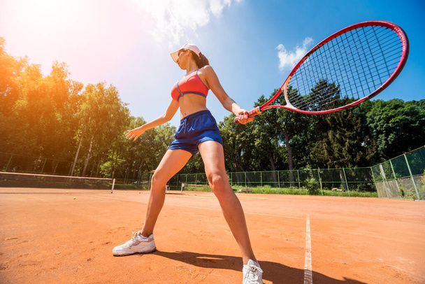 Young athletic woman playing tennis on the court. - Foto, Imagem