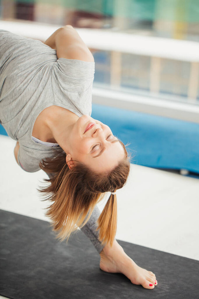 woman practicing yoga , Triangle pose in fitness center - Valokuva, kuva