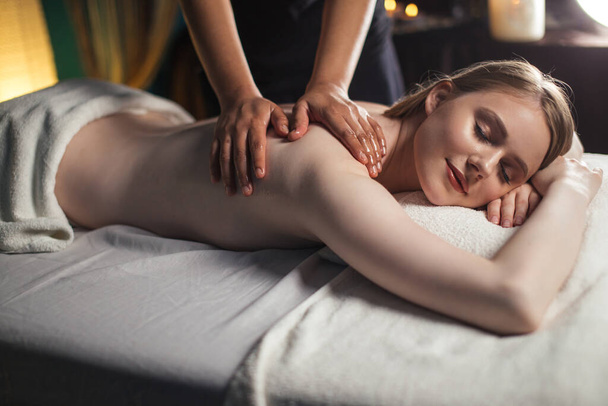 Young attractive woman getting massaging treatment at hospital - Valokuva, kuva