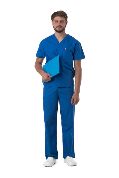 Male nurse in blue uniform with stethoscope and document folder isolated on white background, full length portrait - 写真・画像
