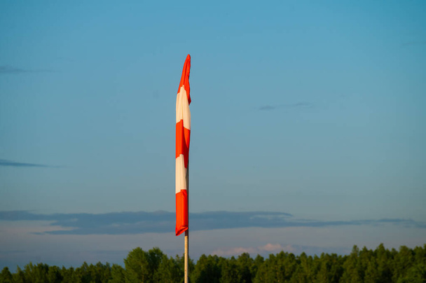 Windsock at the airfield during calm weather - 写真・画像