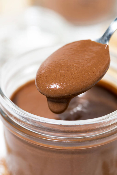 chocolate paste in a glass jar, closeup vertical - Photo, Image