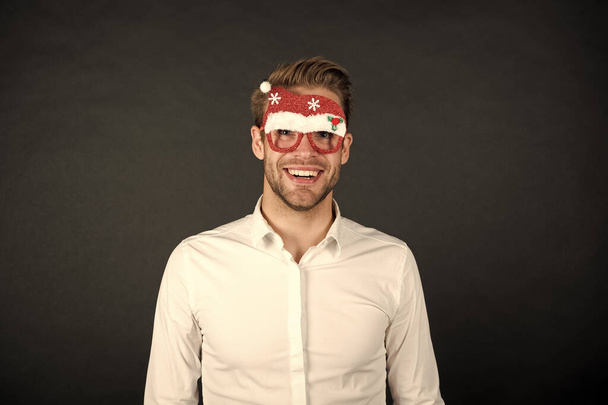 Santa claus coming. Guy celebrate new year. Cheerful ideas for holidays celebration. Happy holidays. Merry christmas. Man white shirt posing with photo booth props. Winter holidays. Corporate party - Photo, Image