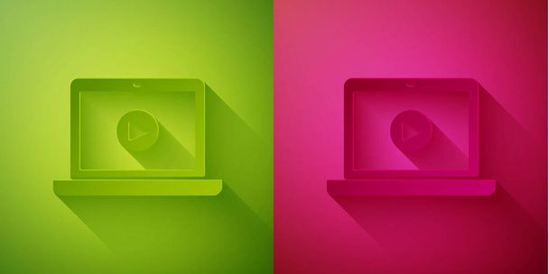 Papír vágott Online játék video ikon elszigetelt zöld és rózsaszín háttérrel. Laptop és filmszalag játéktáblával. Papírművészeti stílus. Vektorillusztráció. - Vektor, kép