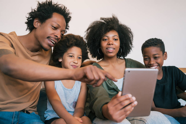 Portrait of african american family taking a selfie together with digital tablet at home. Family and lifestyle concept. - Foto, immagini