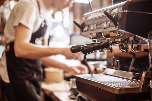 focus on the expresso coffee machine with blurred background - Zdjęcie, obraz