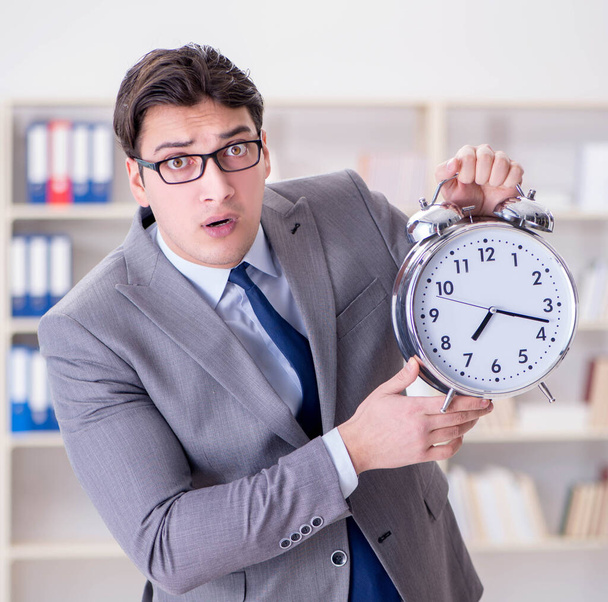 The businessman with alarm clock in the office - Photo, Image
