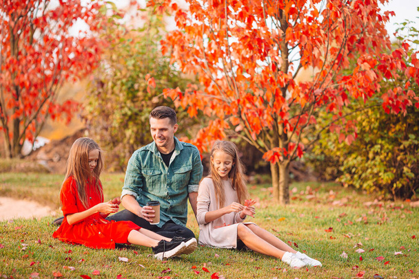 Family of dad and kids on beautiful autumn day in the park - Photo, Image