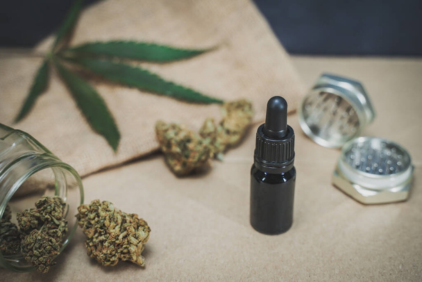 Glass bottle with CBD oil and hemp leaves on wood background. Organic and natural hemp-based cosmetic and beauty products. Medical cannabis concept. Still life. Relaxing incense background. - 写真・画像
