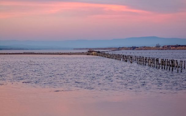 A series of landscapes of a salt lake in a seaside resort. Gentle pink shades of sunset. Pomorie resort, Bulgaria. - Photo, Image