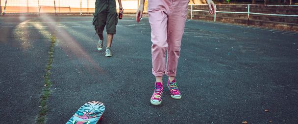 Teen male and female legs with skate board. Banner format - Φωτογραφία, εικόνα