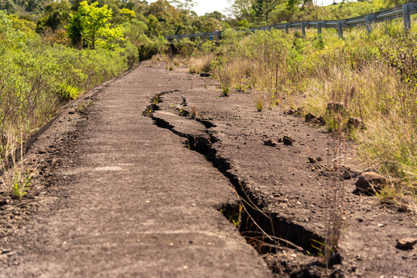 Cracks in the asphalt. Abandoned highway in southern Brazil. Land transport infrastructure - Photo, Image