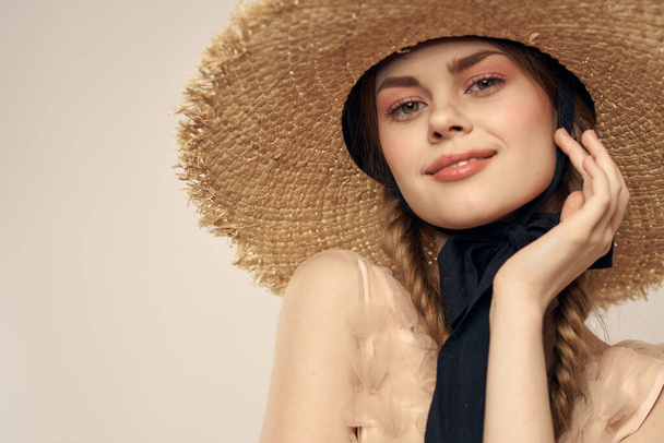 Nice girl in a straw hat with a black ribbon and in a dress on a light background romance model fun emotion - Φωτογραφία, εικόνα