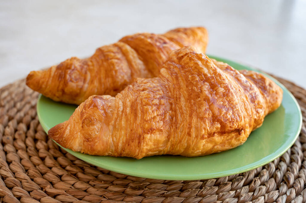 Two french puff pastry croissants from bakery close up - Photo, Image
