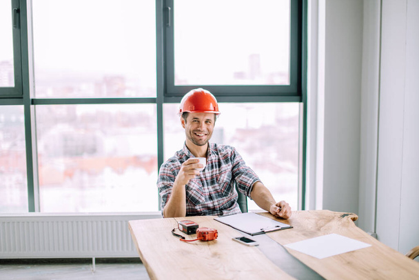 positive construction worker drinking coffee at work - Photo, image