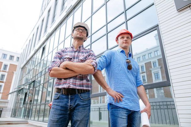 confident awesome constructors in casual clothes are posing to the camera - Фото, зображення