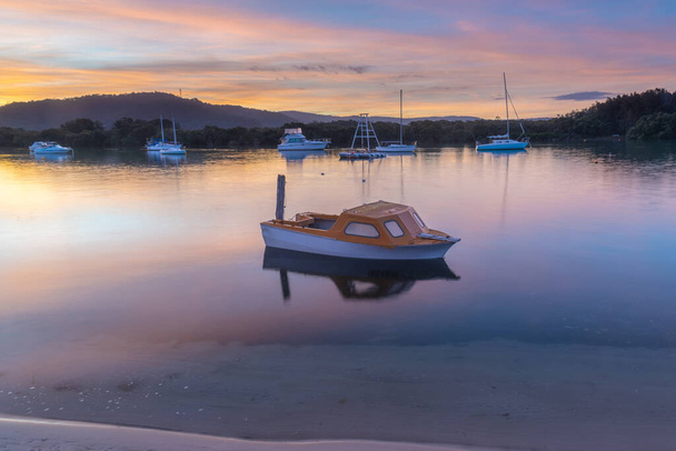 Sunset waterscape with soft high clouds at Woy Woy on the Central Coast, NSW, Australia. - 写真・画像