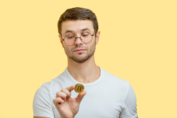 close up portrait of a cute collector who is checking the golden coin - 写真・画像