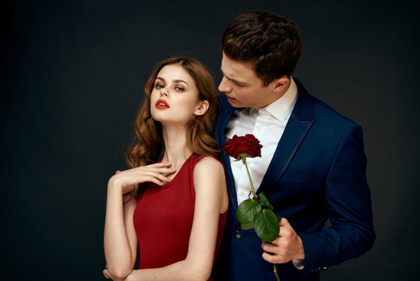 young couple hugs charm red rose relationship black background - Photo, Image