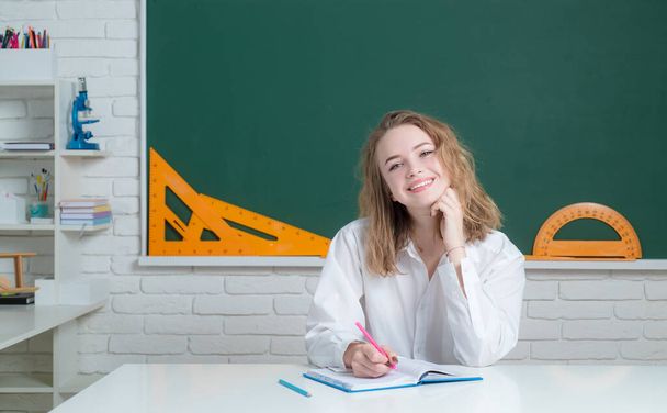 Young happy student on blackboard background. Ready to learn. - Zdjęcie, obraz