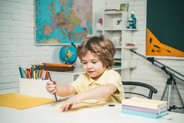 After school teaching. Kid gets ready for school. Schoolkid or preschooler learn. - Фото, изображение