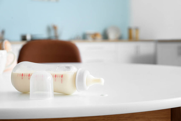 Bottle of milk for baby on table in kitchen - Photo, Image