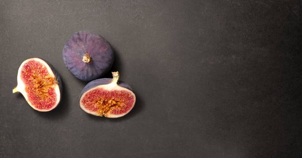 Fresh ripe figs on a black background, top view. - Photo, Image
