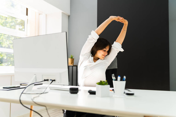 Woman Stretches At Office Desk. Stretch Exercise On Chair - Foto, Imagem