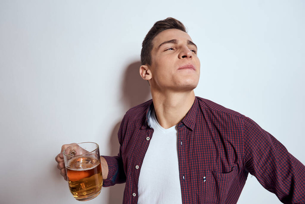 Cheerful man with mug of beer alcohol emotions light background - Fotografie, Obrázek
