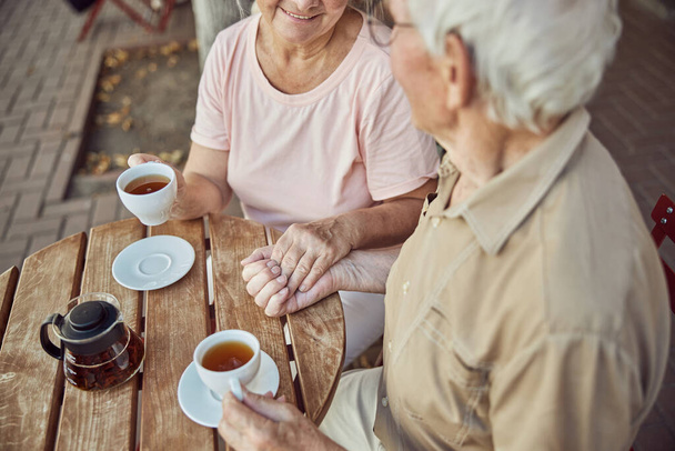 Aged married couple sitting in a street cafe - Photo, Image
