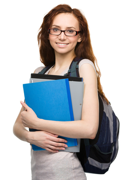 Young student girl is holding book - Φωτογραφία, εικόνα