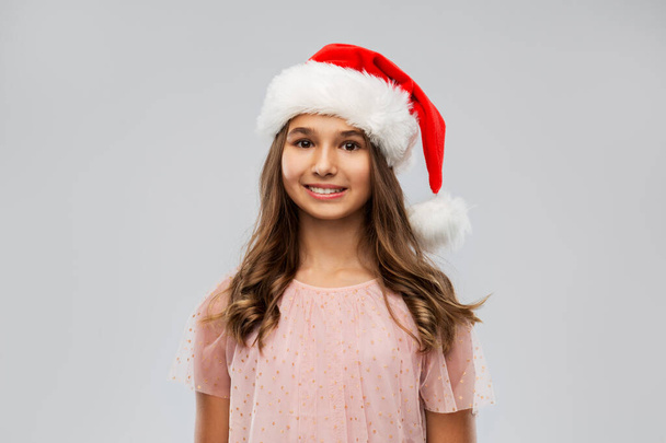 happy teenage girl in santa hat on christmas - Foto, afbeelding