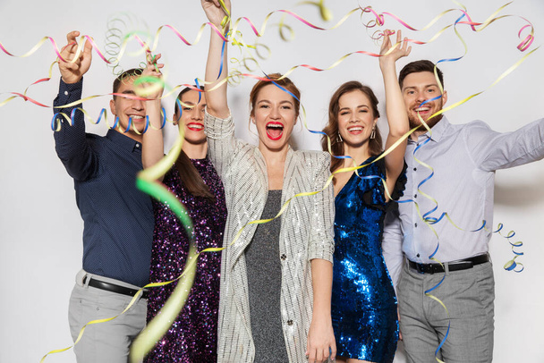 friends throwing party streamers and having fun - 写真・画像
