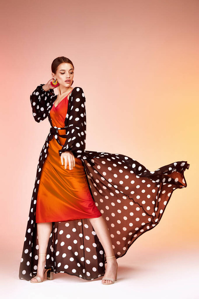 Glamour fashion woman long brunette hair natural evening makeup wear sexy silk long dress polka dot and red stylish from new catalog spring summer collection accessory jewelry earring body shape care. - Фото, зображення