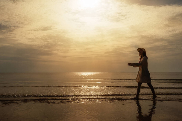 cheerful woman in bikini walking on the sea beach - 写真・画像