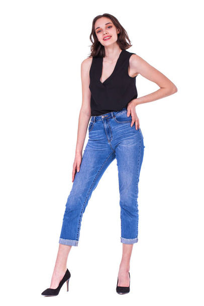 Full body portrait of a young beautiful brunette model in blue jeans, isolated on white background - Фото, зображення