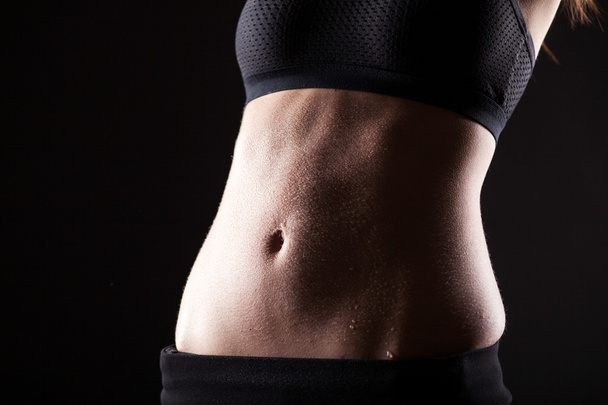 Woman wet sporty belly after exercise - Photo, Image