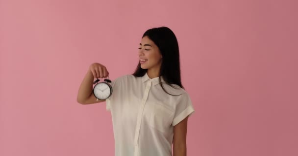 Amazed woman showing time on alarm clock - Footage, Video