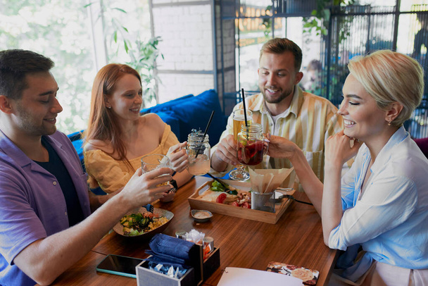 beautiful caucasian men and women hold friendly meeting in cafe - Valokuva, kuva