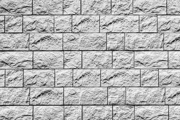 Black and white texture of a wall covered with decorative brick-like tiles. Abstract monochrome background for design. - Photo, Image