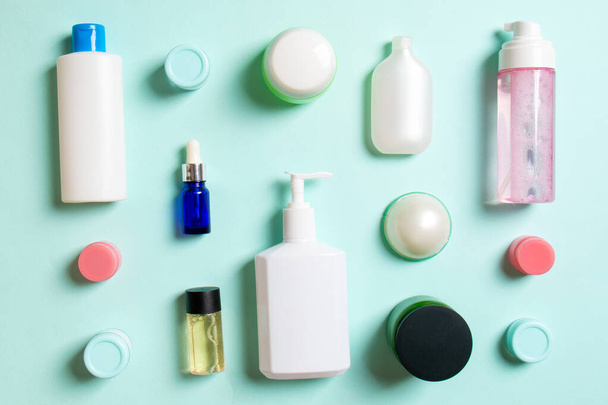 Group of plastic bodycare bottle Flat lay composition with cosmetic products on colored background empty space for you design. Set of White Cosmetic containers, top view with copy space. - Fotoğraf, Görsel