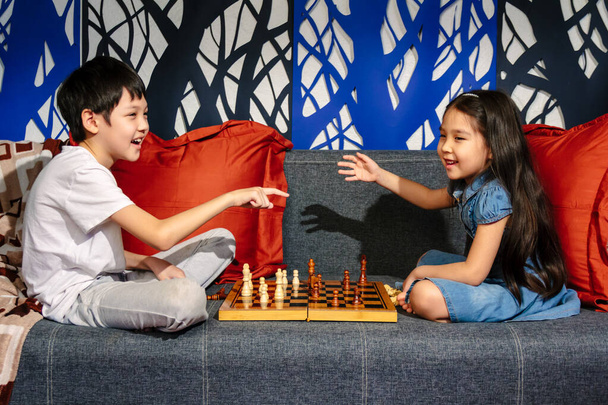 Sweet funny family moments during lockdown, children playing chess - Photo, Image