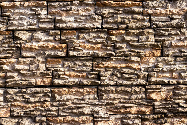 Monochrome texture of a wall covered with decorative brick-like tiles. Abstract background for design. - Photo, Image
