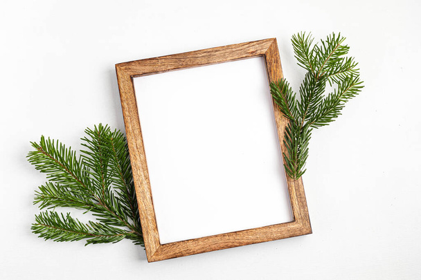 Eco friendly Christmas holidays decoration. Christmas tree branches  and wooden frames. Winter holidays mockup, sustainable lifestyle concept - Photo, Image