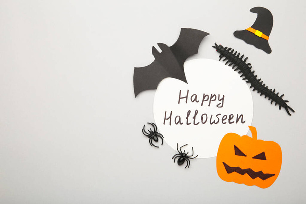 Halloween composition with spiders and bats on grey wooden background. Top view - Foto, Bild