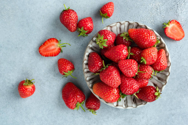 Strawberries on grey concrete background - Фото, изображение